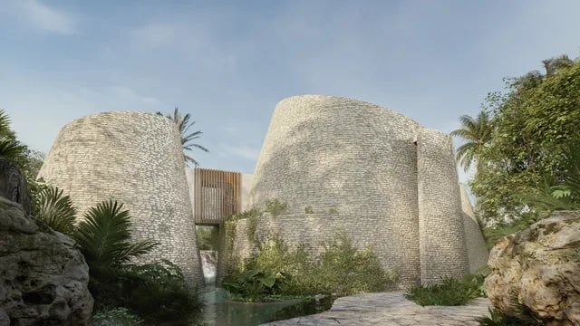 The Aflora spa: two curved stone towers among palms and jungle, a wooden bridge between them