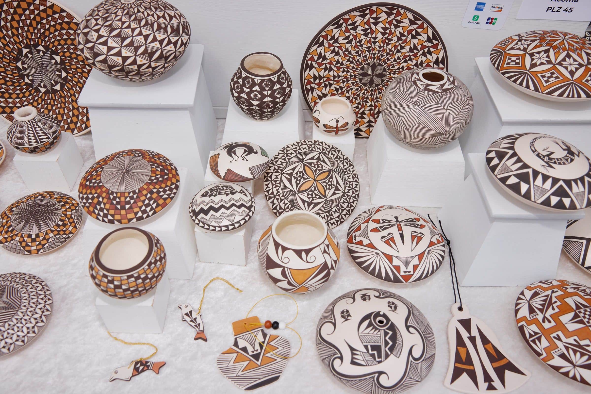 Acoma pottery with fine black and white designs displayed at Santa Fe Indian Market