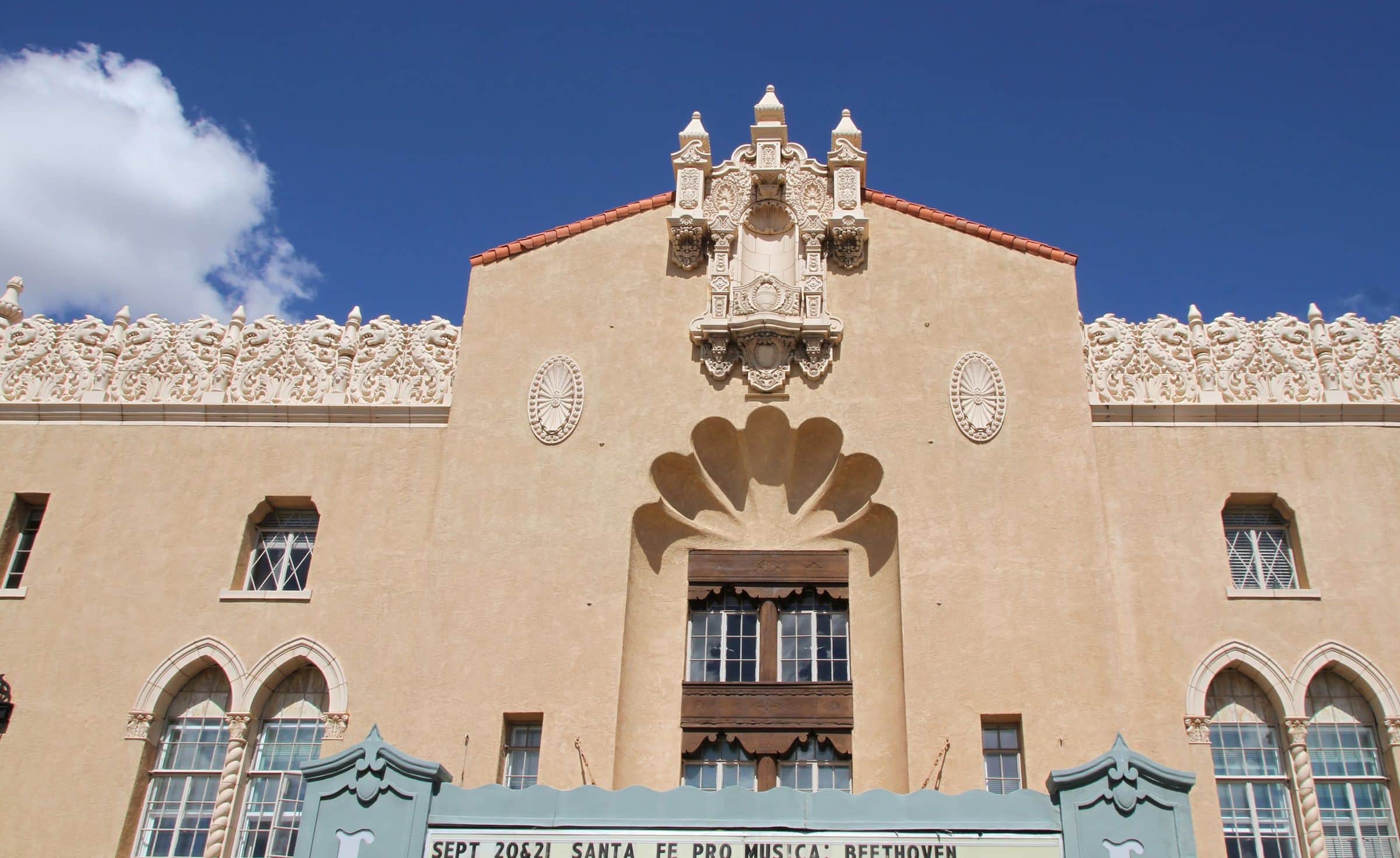The ornate Spanish Colonial Revival facade of the Lensic Performing Arts Center against a blue sky