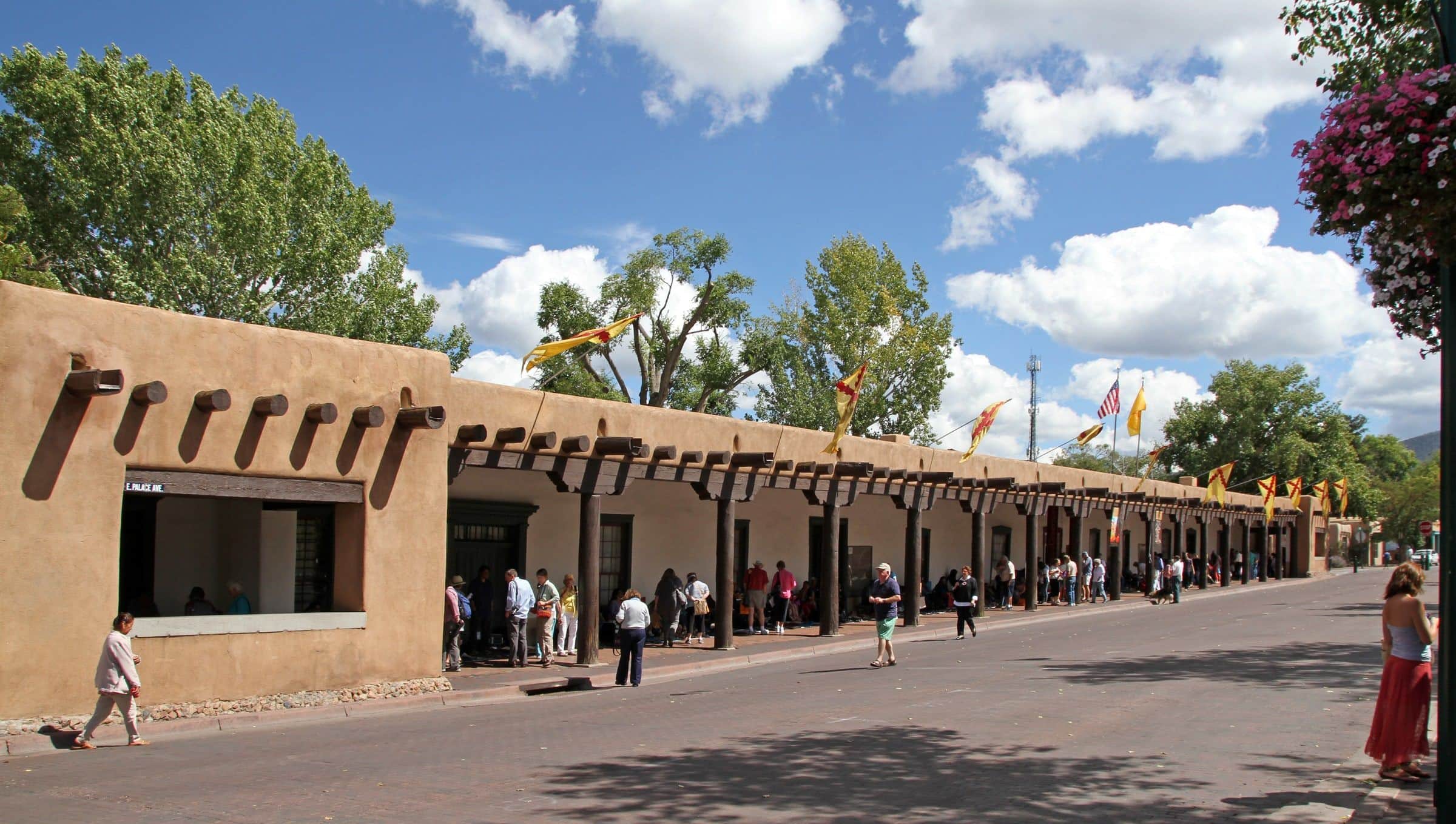 The long portal of the Palace of the Governors on the Santa Fe Plaza under a summer sky