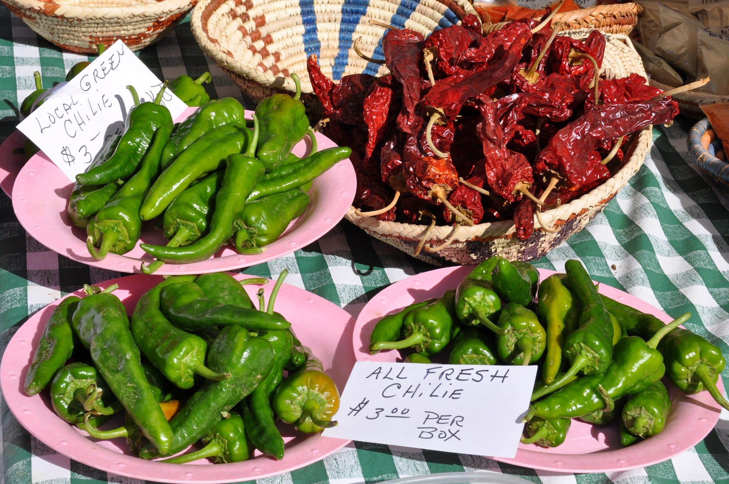 Green chile and dried red chile in baskets at a Santa Fe farmers' market